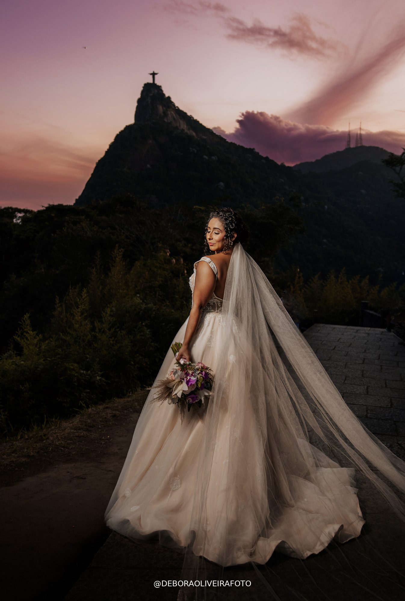 Bride with veil at dusk with Cristo Redentor - Rio de Janeiro elopement photography